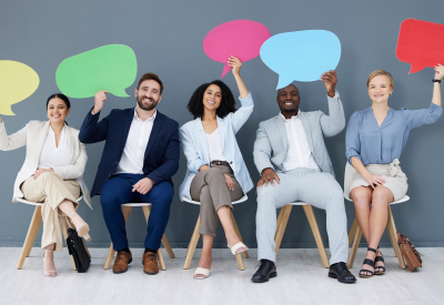 Diversity, business people and speech bubbles for social media, recruitment and feedback in workplace. Multiracial, happy employees and coworkers with happiness, interview or collaboration for survey